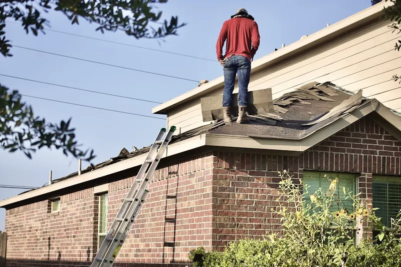 Professional roofer working on a residential roof in Charred Oak Estates